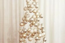 a neutral floating Christmas tree composed of silver, white and glitter ornaments is a great idea for a neutral space