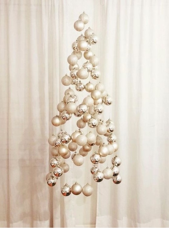 a neutral floating Christmas tree composed of silver, white and glitter ornaments is a great idea for a neutral space