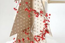 a pegboard Christmas tree decorated with himmeli ornaments and berries placed on faux fur is a great tabletop idea