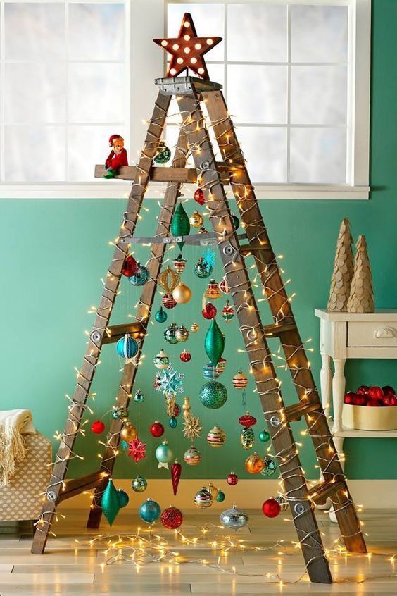 a pretty ladder Christmas tree with lots of colorful ornaments and lights is an amazing decoraiton you cna easily DIY