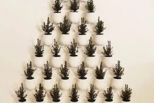 a super creative Christmas tree formed of potted evergreens that are attached to the wall