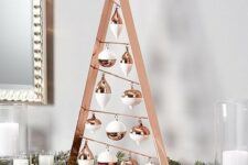 a tabletop copper frame Christmas tree with white and copper ornaments is great for mantels and tables