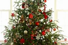 a traditional Nordic Christmas tree with metallic, red and white ornaments of various shapes and letters plus lights
