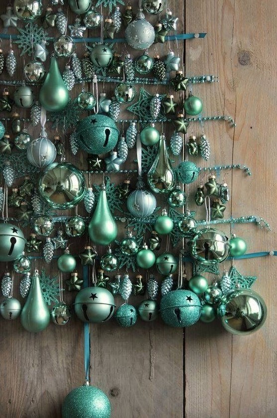 a wall Christmas tree composed of green ornaments of various sizes, stars and jingle bells plus bead garlands is a very creative idea