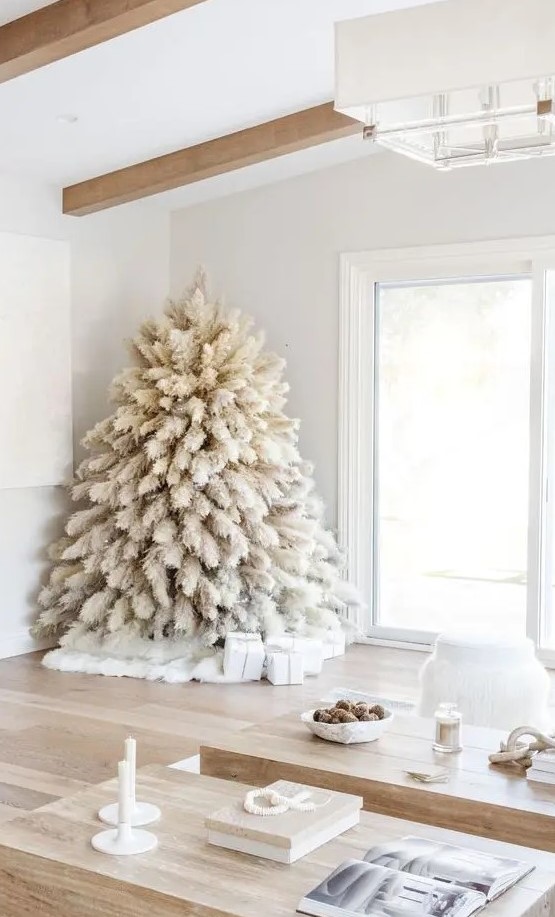 a white pampas grass Christmas tree with no decor and only lights is a fntastic solution for a boho feel in the space