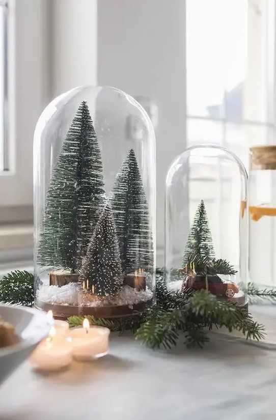 cloches with bottle brush Christmas trees, faux snow and a small car are amazing for holiday styling
