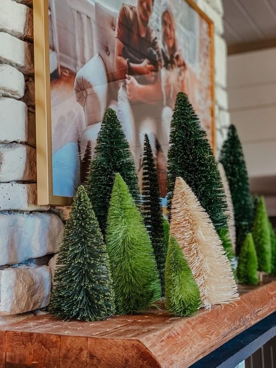 cool woodland Christmas mantel decor with various bottle brush trees in green and neutrals is easy and cool