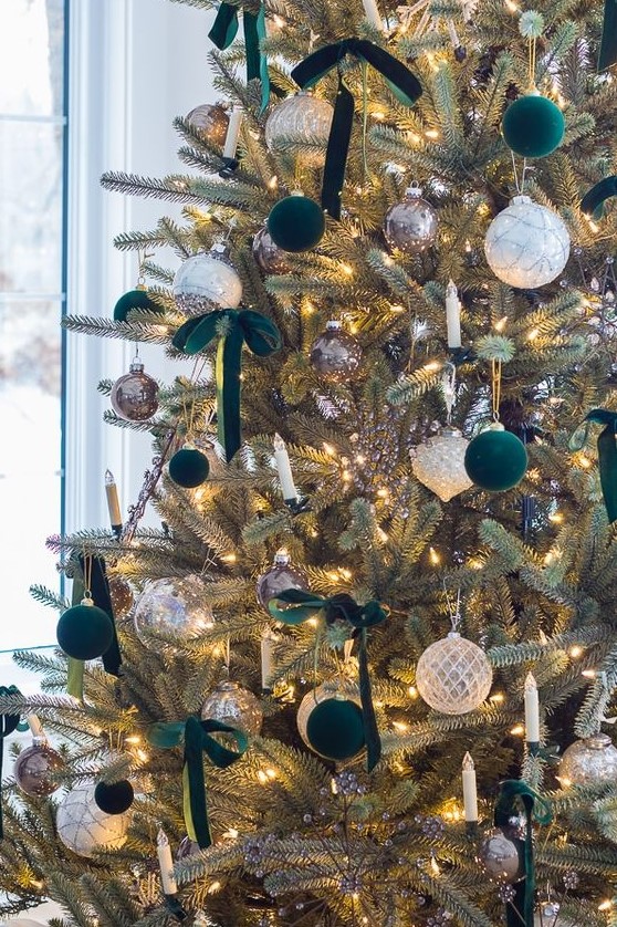 elegant and refined Christmas tree decor with white, silver and dark green velvet ornaments plus lights and dark green bows