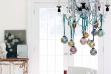 hang some pastel Christmas ornaments on yoru chandelier to make it cute and chic