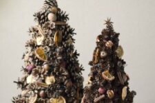 pinecone Christmas tree decorated with cinnamon sticks, nuts, citrus and dried fruits for a rustic feel