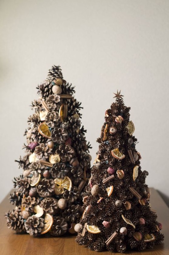 pinecone Christmas tree decorated with cinnamon sticks, nuts, citrus and dried fruits for a rustic feel