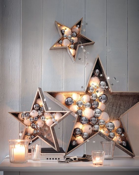 plywood stars filled with white and silver ornaments and lights are cute and chic festive decor options