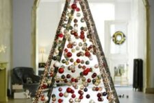 take a usual ladder and cover it with lights, then attach Christmas ornaments on various heights to form a creative tree