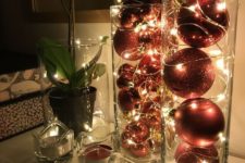 tall glass vases filled with red and red glitter ornaments and lights are amazing as holiday decor