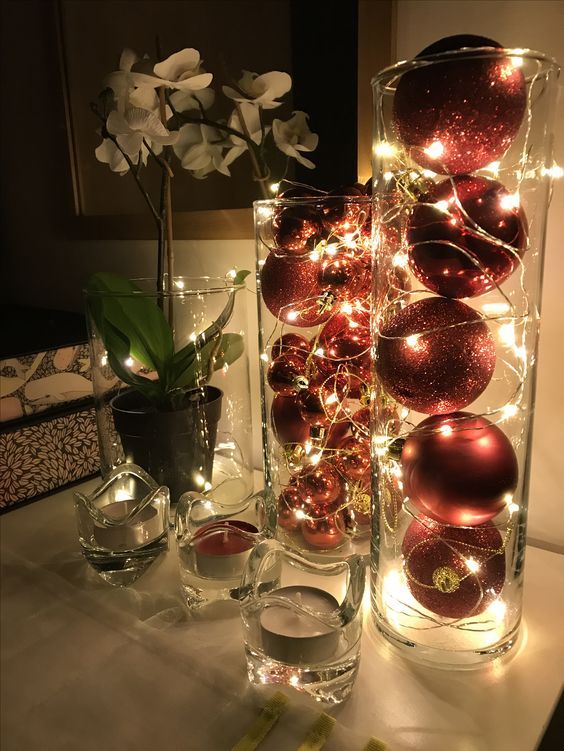 tall glass vases filled with red and red glitter ornaments and lights are amazing as holiday decor