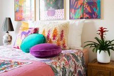 a cheerful bedroom made colorful with a bold gallery wall and bright bedding and pillows is a fun and cool idea to rock