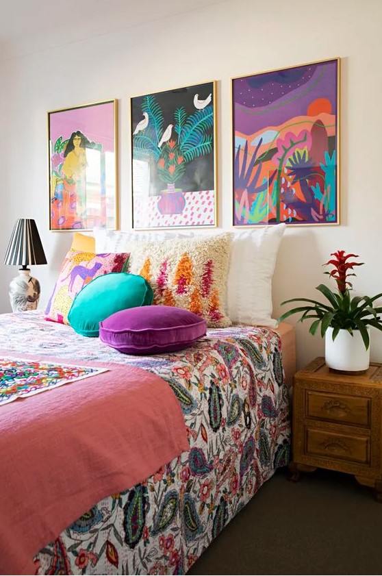 a cheerful bedroom made colorful with a bold gallery wall and bright bedding and pillows is a fun and cool idea to rock