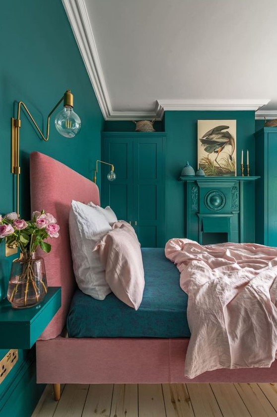 a colorful bedroom with brass wall sconces and some other brass touches that bring luxury and chic in