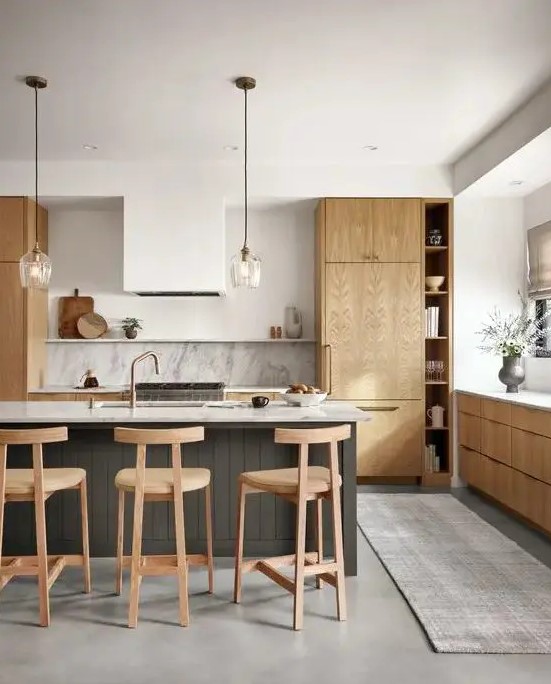 a contemporary kitchen with light stained cabinets, a white hood, a stone backsplash and countertops plus a grey planked kitchen island