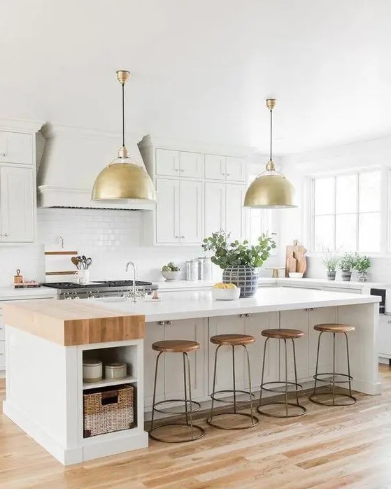 a creamy modern country kitchen with shaker style cabinets, a large kitchen island with storage, gold pendant lamps