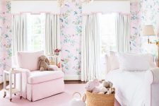 a cute and sweet girl’s bedroom with floral wallpaper, a pink rug and a chair, an upholstered bed and a basket