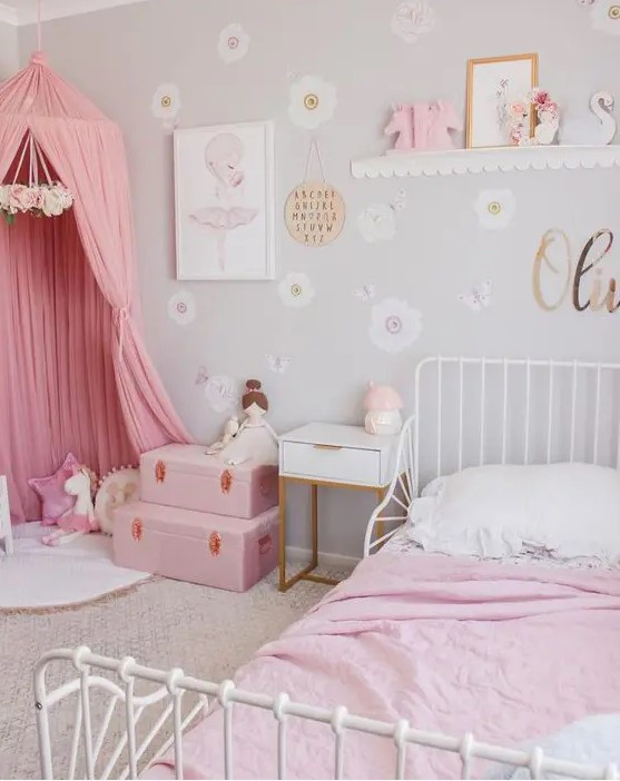 a dove grey girl's room with white furniture, pink bedding, a pink teepee, pink suitcases and various toys is awesome