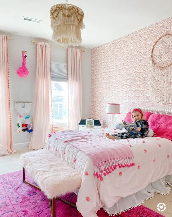 a fantastic pink boho girl's bedroom with a pink wallpaper wall, light pink curtains, a bed with hot pink pillows and a hot pink rug