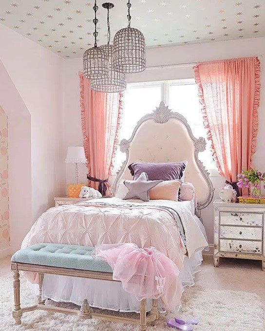 a fun and cool girl's room with a refined bed with an extended headboard, mirror nightstands and blooms, purple and blush bedding and a turquoise bench