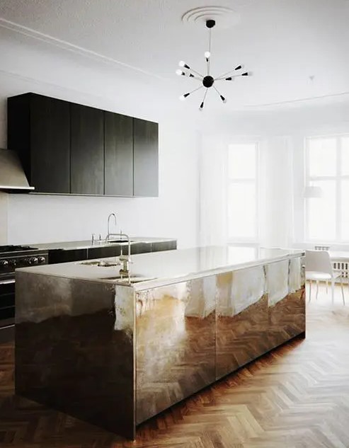 a minimal black kitchen with a shiny metal kitchen island that brings a glam feel to the space and make it stand out a lot