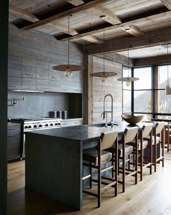a minimalist chalet kitchen with sleek wooden cabinets and a wooden ceiling and walls, a stone kitchen island and leather chairs