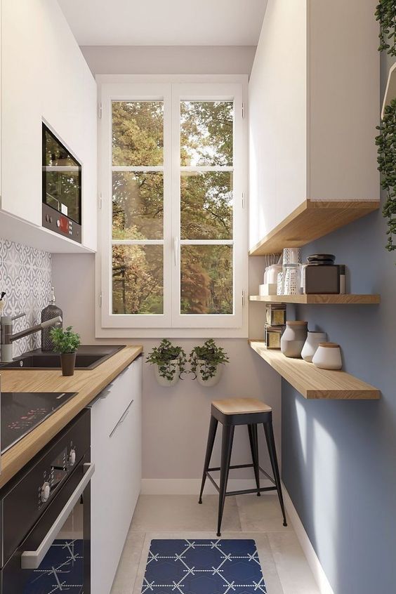 a minimalist kitchen with white cabinets, a top cabinet and open shelves, a stool and a printed rug