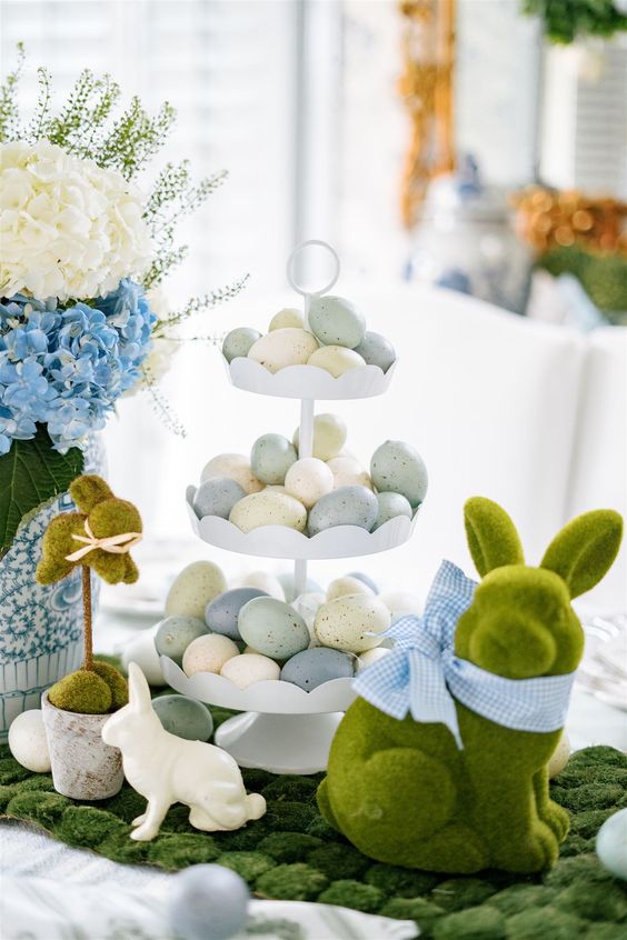 Easter decor with moss, a moss bunny, a tiered stand with pastel eggs and fresh blooms is amazing