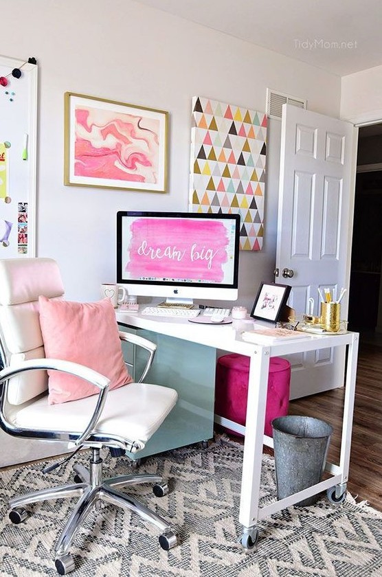 a bright home office with a white desk and chair, a pink pillows and a colorful gallery wall plus a purple stool