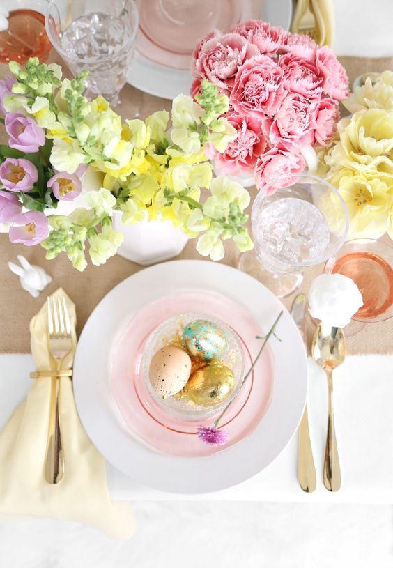 a cluster floral Easter centerpiece of pink and yellow blooms is an amazing idea to create a spring feel at the table