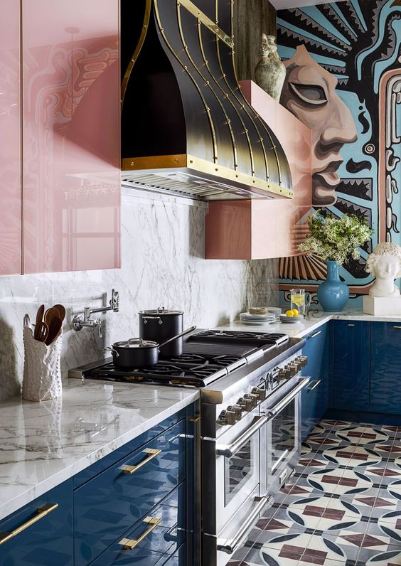 A Colorful Kitchen With Navy Lower Cabinets Pink Upper Ones A Marble Backsplash And A Vintage Hood To Make A Statement 