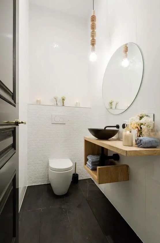 a creative wooden geometric vanity with a metal sink and towel storage