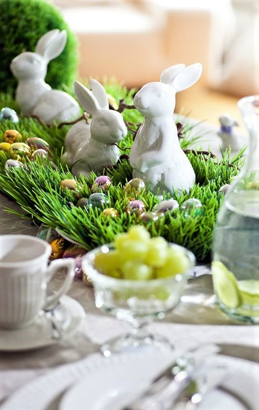 a fun Easter centerpiece of grass, matellic eggs and bunnies is a super cool decoration to make for your table