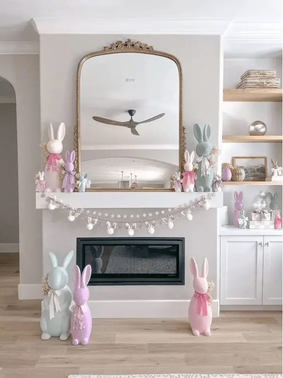 a fun and playful Easter mantel with pastel bunnies, a galrand and a banner, some faux blooms and bunnies around