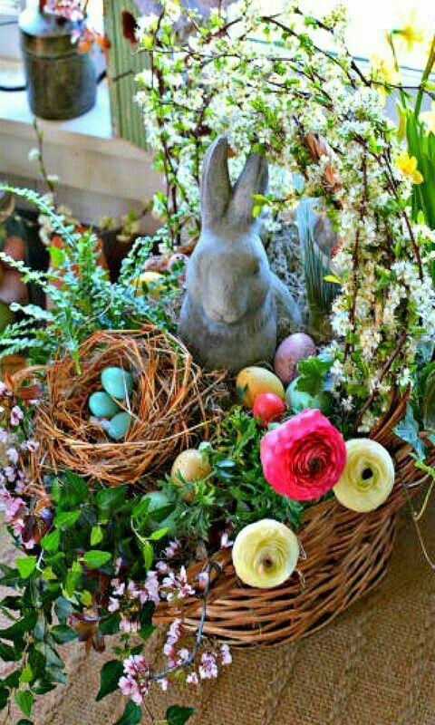a gorgeous colorful Easter decoration of a basket with bright blooms, a faux nest with eggs and a bunny is a cool idea to rock
