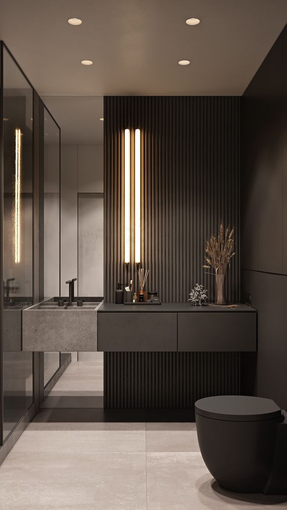 a minimalist black powder room with matte walls and wooden slats, a built-in vanity, lights and a mirror