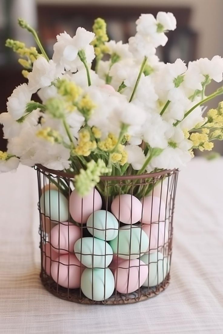 a pretty Easter centerpiece of a wire basket with pastel eggs and white blooms is gorgeous