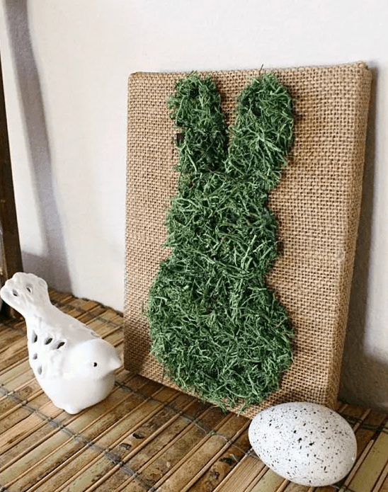 a pretty burlap artwork with a moss bunny is a lovely decoration for a rustic space and it's not difficult to make