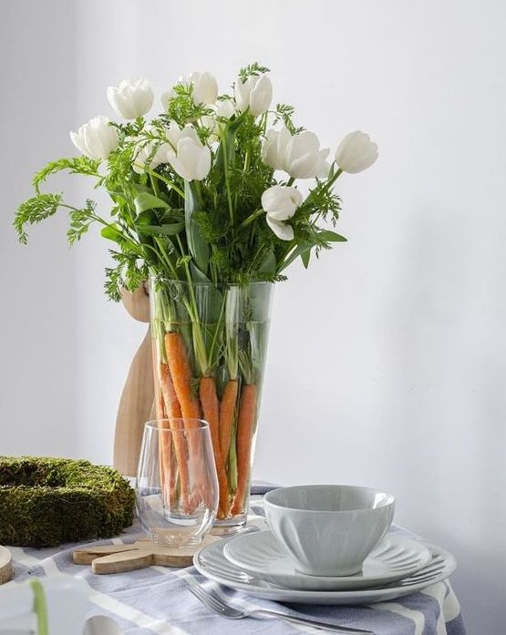a quick and simple Easter or spring centerpiece of carrots, white tulips and greenery is amazing
