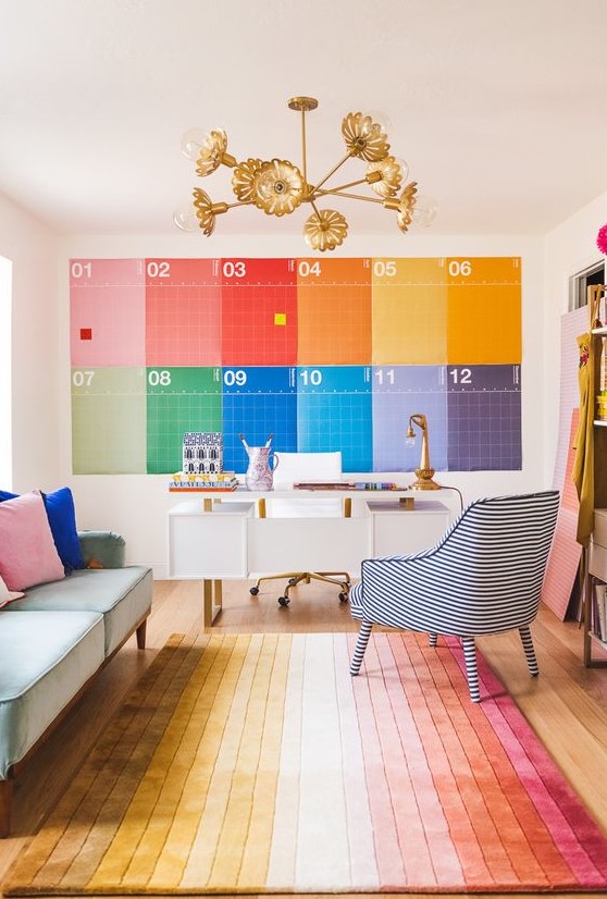 a rainbow home office done with all the colors of the rainbow, with a white desk, a pastel sofa and a striped chair just wows