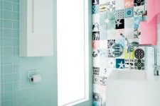 a small and cool powder room clad with light blue and printed tiles, with a pink storage unit and white appliances