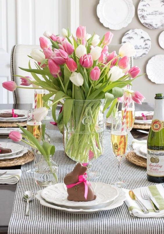 a spring wedding centerpiece of a clear vase with pink and white tulips is a cool last-minute idea