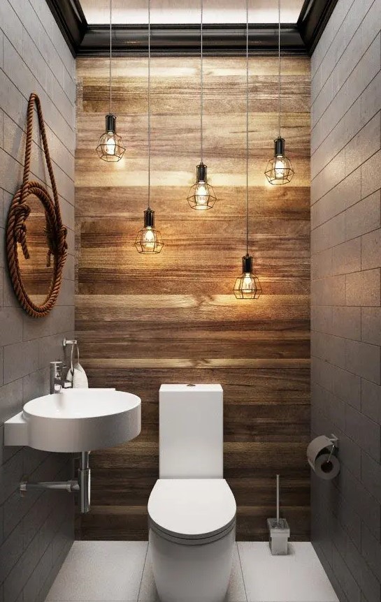 a wood accent wall and lots of industrial geo bulbs hanging over the toilet