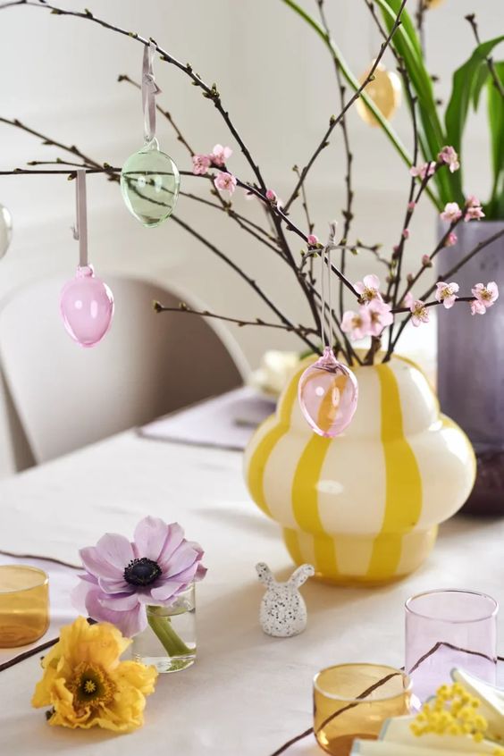 blooming cherry blossom branches with sheer pastel eggs are a cool decoration or centerpiece for spring or Easter