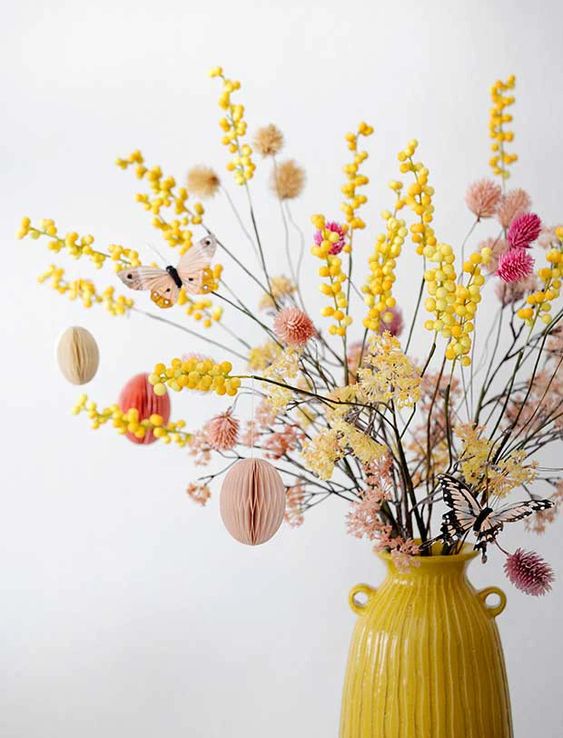 bold dried branches in yellow and pink, with paper eggs in pink, neutrals and coral are amazing for Easter decor