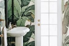 eye-catchy banana leaf wallpaper makes the powder room eye-catchy and bold